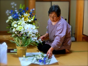 Flowers for her husband. 1 Hitoko arranges flowers for the 49 day ceremony.  Himeji. 2015.