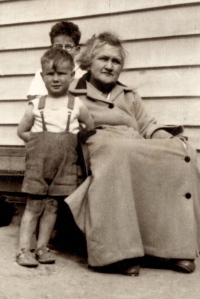 Katie Stevens (nee Goodwillie) our Nana weeks before she died, with two of her grandsons; Neil (obscured) and Paul. Forest Street Tapanui.  One of my earliest photos taken on a box Brownie when I was about 8 years old.